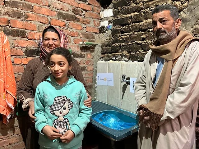 Villagers beside a new water and sanitation installation
